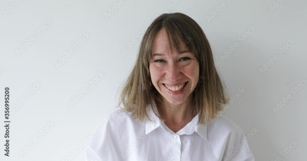 Portrait young woman looking at camera with happy emotion enjoying successful lifestyle on white background Portrait young woman looking at camera with happy emotion enjoying successful lifestyle on white background