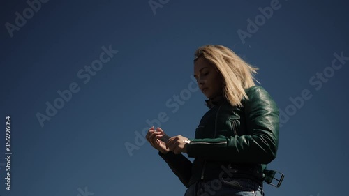 young woman sawing the nails in the street sawing