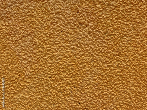Background Gold Yellow Color textures of decorative plaster on the wall of the house.