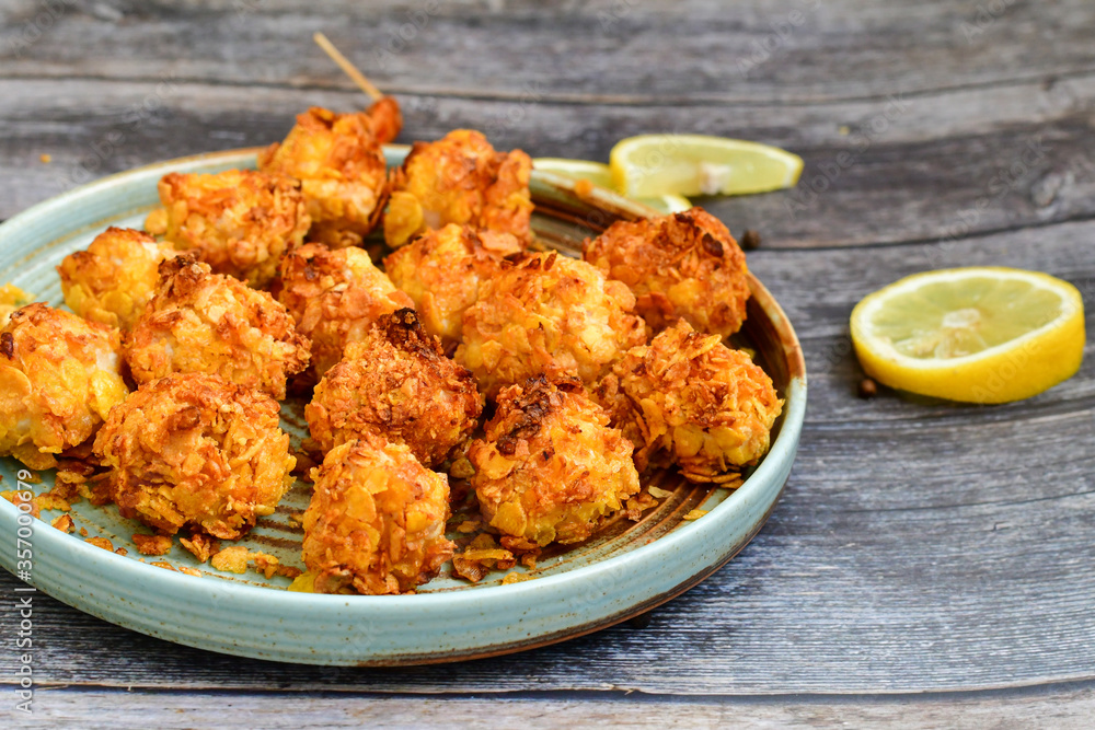 Home made Crispy Chicken Popcorn with honey mustard sauce on wooden background Home made Crispy Chicken Popcorn with honey mustard sauce on wooden background