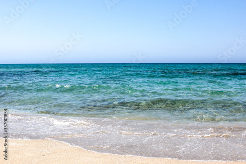 Coast with waves as a background. Blue water seascape. Summer.
