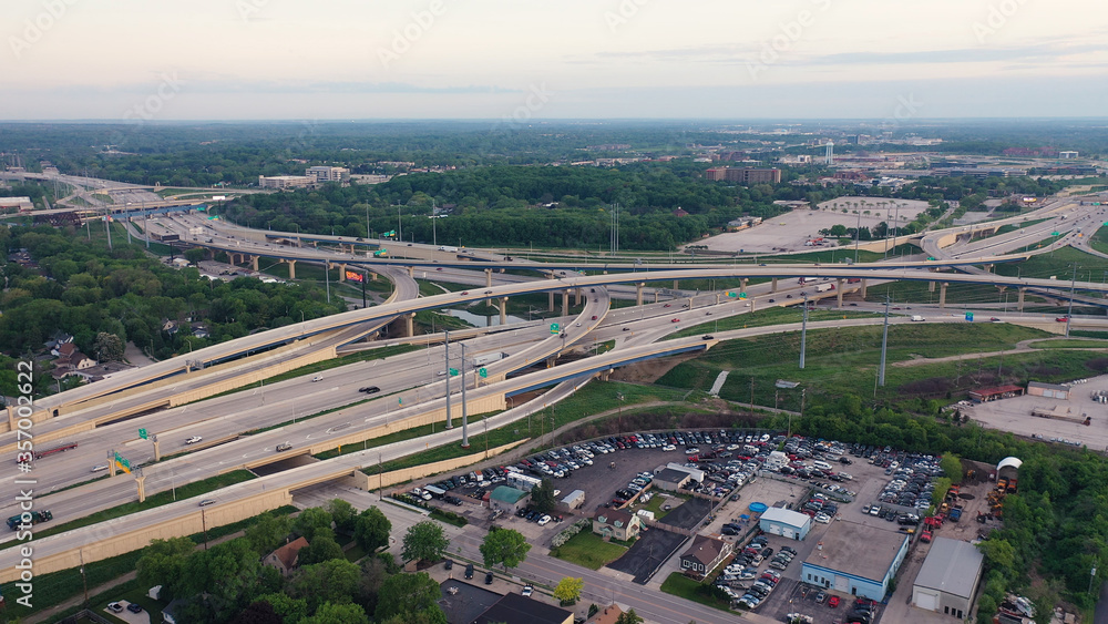 Fototapeta premium Aerial view of road intersection at summertime. Drone shot, highway from above