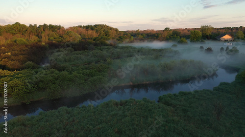 Aerial view of american countryside in the summertime. Sunrise, dawn, misty early morning. North american rural landscape, Beautiful nature of Midwest