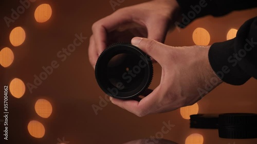 Hand model opens and closes aperture on a cine lens. photo