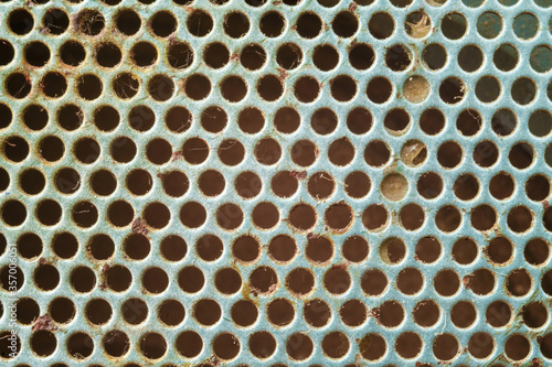 Rusty silver metal background with holes