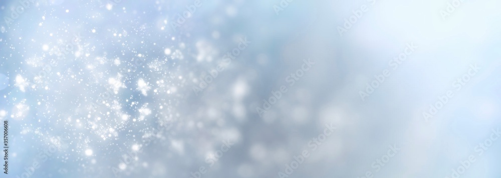 White snowflakes on a blue background fall from the sky - Christmas and winter background banner