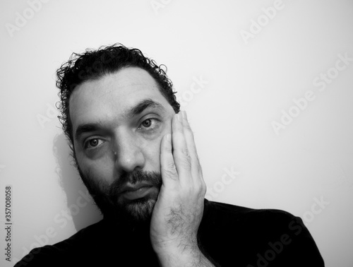 Close-up portrait of a handsome young man with brave manly face. Male beauty.