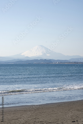 Japan, Fuji mountain or Fuji-San and sea, beach view in sunny blue sky day  and sea wave in moving, Enoshima, Kanagawa, Portrait background image direction © simpletun