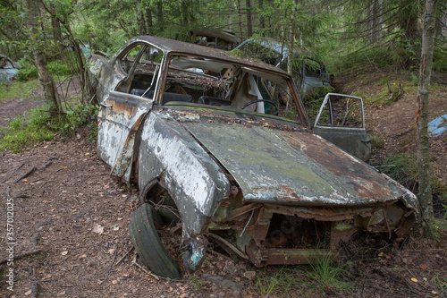 Old cars in Sscrapyard in forest in Ryd Sweden