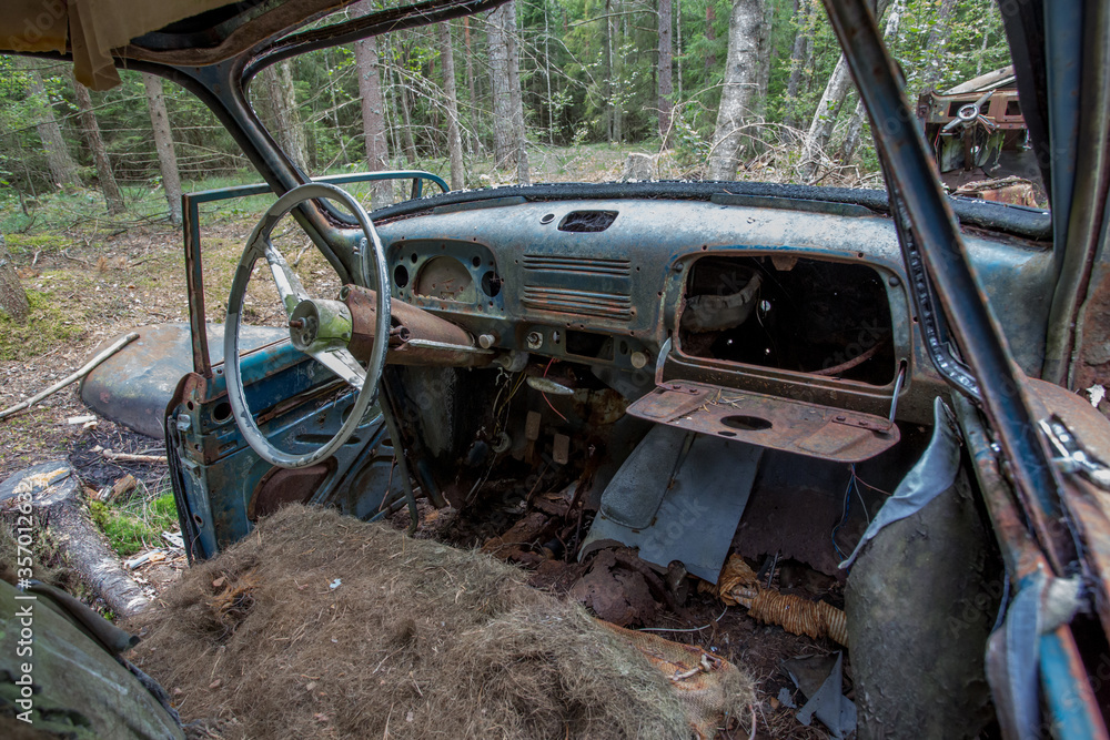 Old cars in Sscrapyard in forest in Ryd Sweden