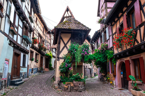 A street in Eguisheim, Alsace, France, with historic buildings and typical Alsatian architecture