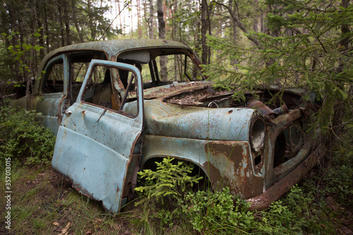 Old cars in Sscrapyard in forest in Ryd Sweden © Joost Adriaanse