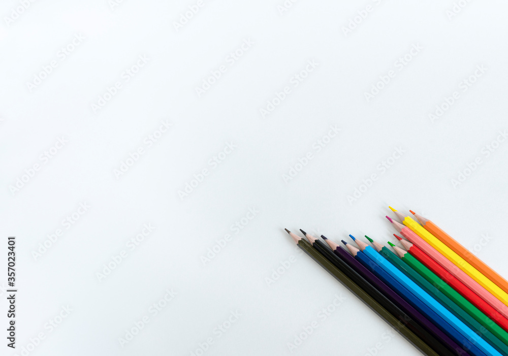 Colored pencils on white background with space for text. Set of colored pencils. Colors of rainbow.