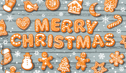 Merry Christmas greeting card. Text made of gingerbreade cookies on old wooden background