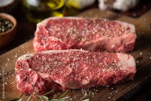 seasoned raw sirloin beef steak on cutting board