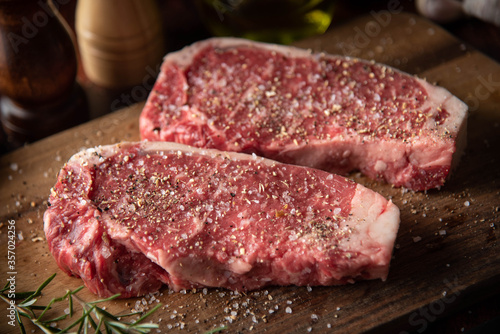 seasoned raw sirloin beef steak on cutting board