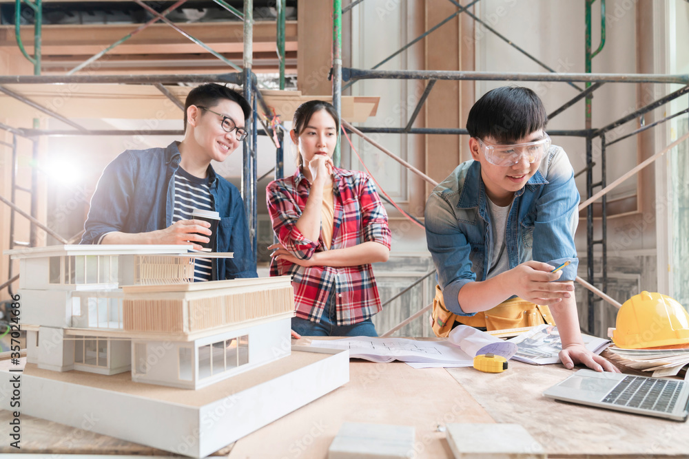 group of smart asian architect interior design team consulting with ...