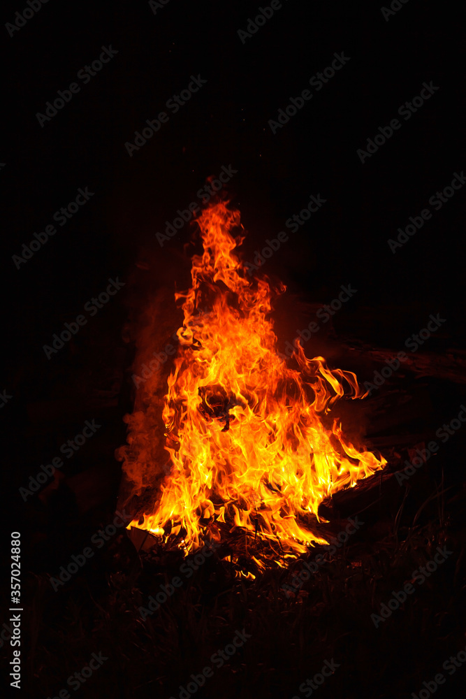 High bonfire flame at night