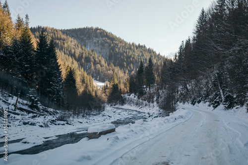 A man riding skis down a snow covered mountain