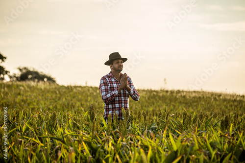 Freedom Brazilian farmer man stand at the green farm with gratitude.