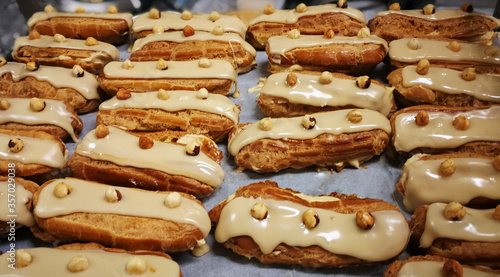 Close up French dessert eclairs with filling, glaze and nuts. Backgrounds © PhotobyKristi