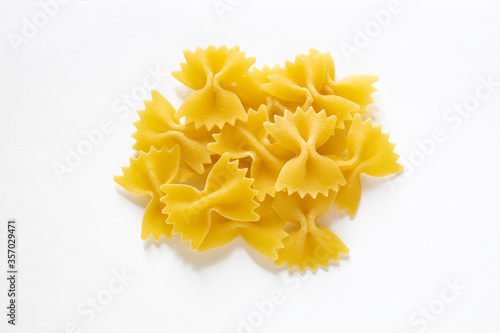 traditional italian farfalle pasta isolated on a white background, a pile of a bow tie pasta , noodles made from durum wheat