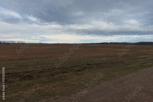 Gloomy steppe landscape. Beautiful cloudy sky over the field.