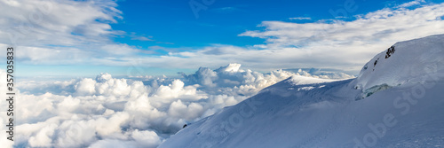 Blue sky background with tiny clouds in panoramic view. Mount Blanc. © marabelo