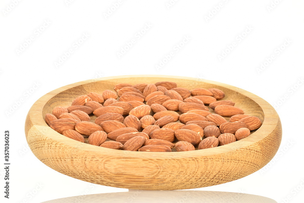 Roasted flavored almonds, close-up, on a white background. Roasted flavored almonds, close-up, on a white background.