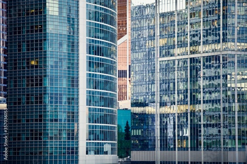 Office and residential skyscrapers in city downtown close up. Commercial real estate. Financial city district. Modern business city district. Office buildings exterior and facade design. In the city.