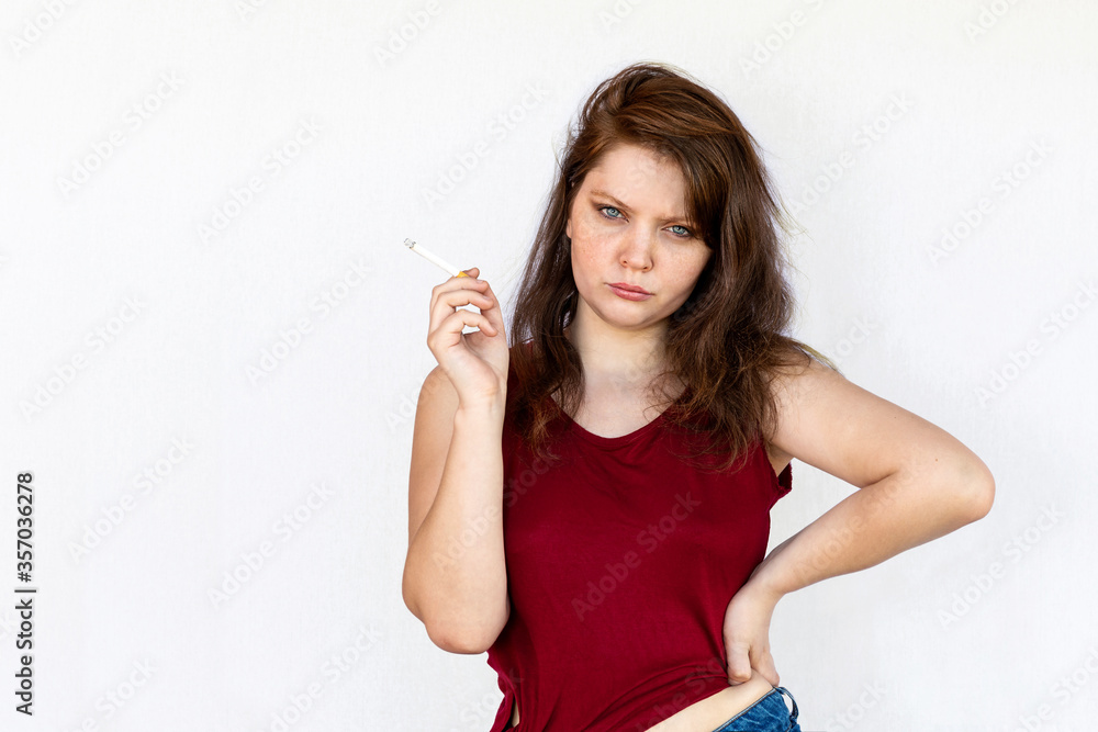 Girl smokes a cigarette - Half-length portrait of a young woman on a white background. Girl smokes a cigarette - Half-length portrait of a young woman on a white background.