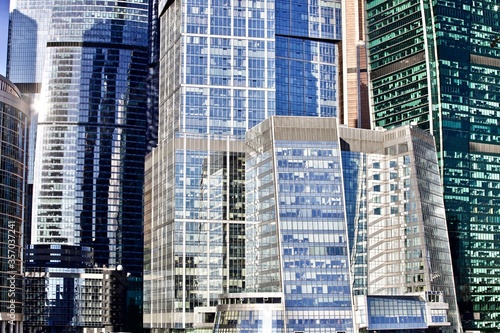 Office and residential skyscrapers on bright sun and clear blue sky background. Commercial real estate. Modern business city district. Office buildings exterior. Financial city district. Downtown.