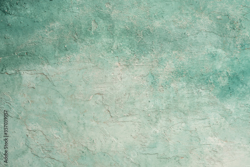green and white painted grungy rough stucco wall background