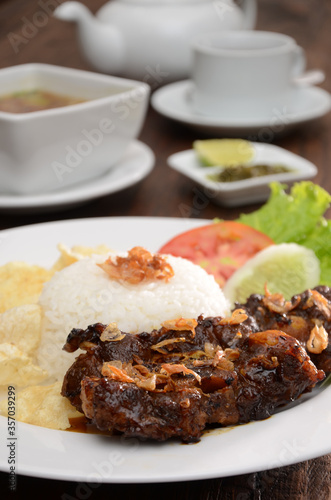 fried oxtail with rice, garnish and sambal