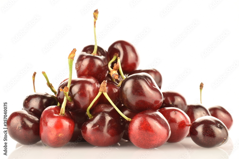 Ripe juicy organic sweet cherry, close-up, on a white background. Ripe juicy organic sweet cherry, close-up, on a white background.
