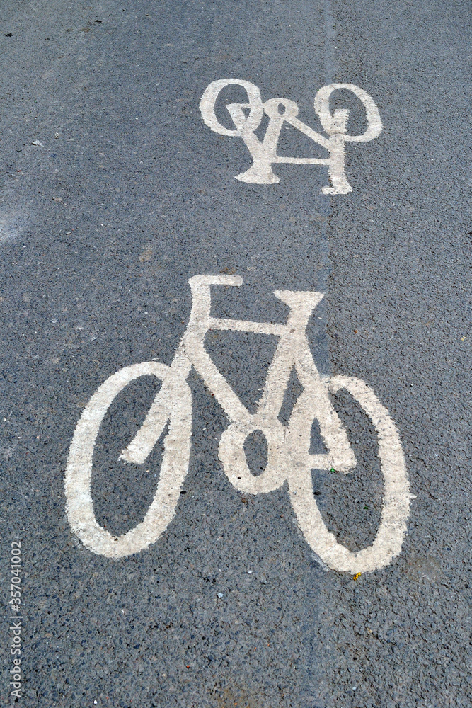 Bicycle Signs Painted on Grey Tarmac of Empty Public Road Bicycle Signs Painted on Grey Tarmac of Empty Public Road