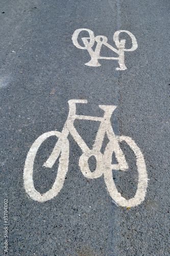 Bicycle Signs Painted on Grey Tarmac of Empty Public Road 