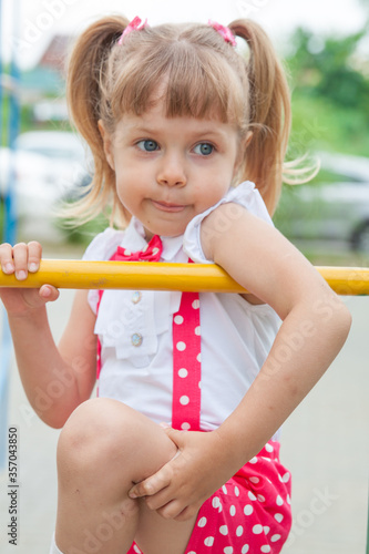 Little girl baby with tails in holiday clothes