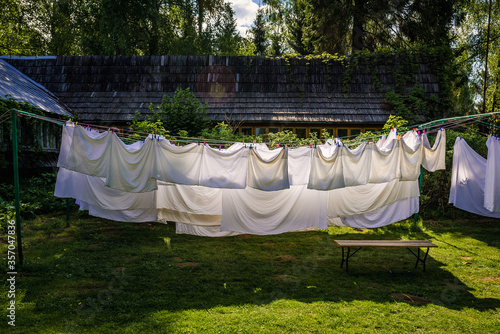 Sheets and pillow cases dries on a rope in the garden photo