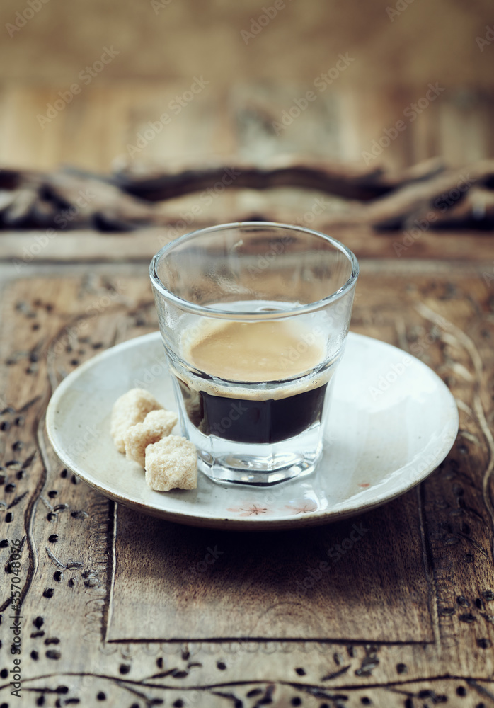 Coffee in glass cup on rustic wooden background. Coffee in glass cup on rustic wooden background.