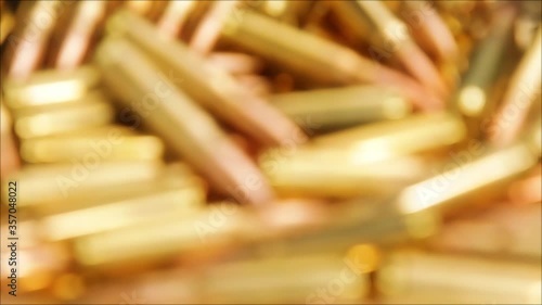 Focusing over pile of golden rifle ammunition