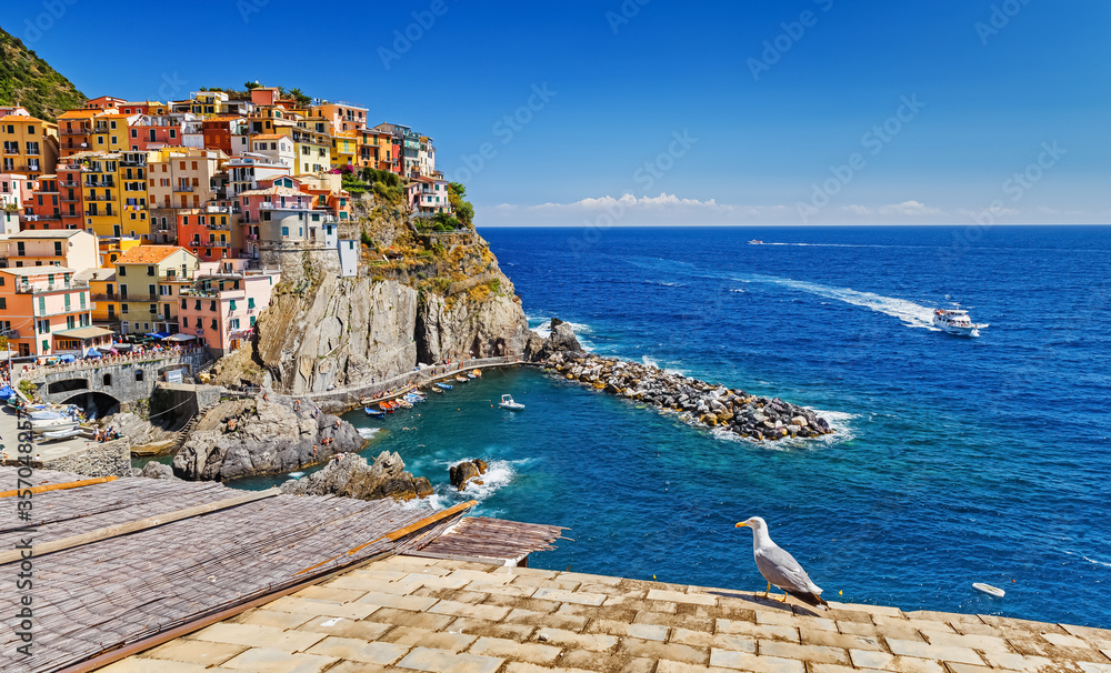 Italy, Manarola. Cinque Terre National Park, Seaside Panorama of picturesque colorful houses of ancient village Manarola at cliff, UNESCO world heritage site.