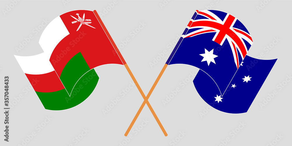 Crossed and waving flags of Oman and Australia