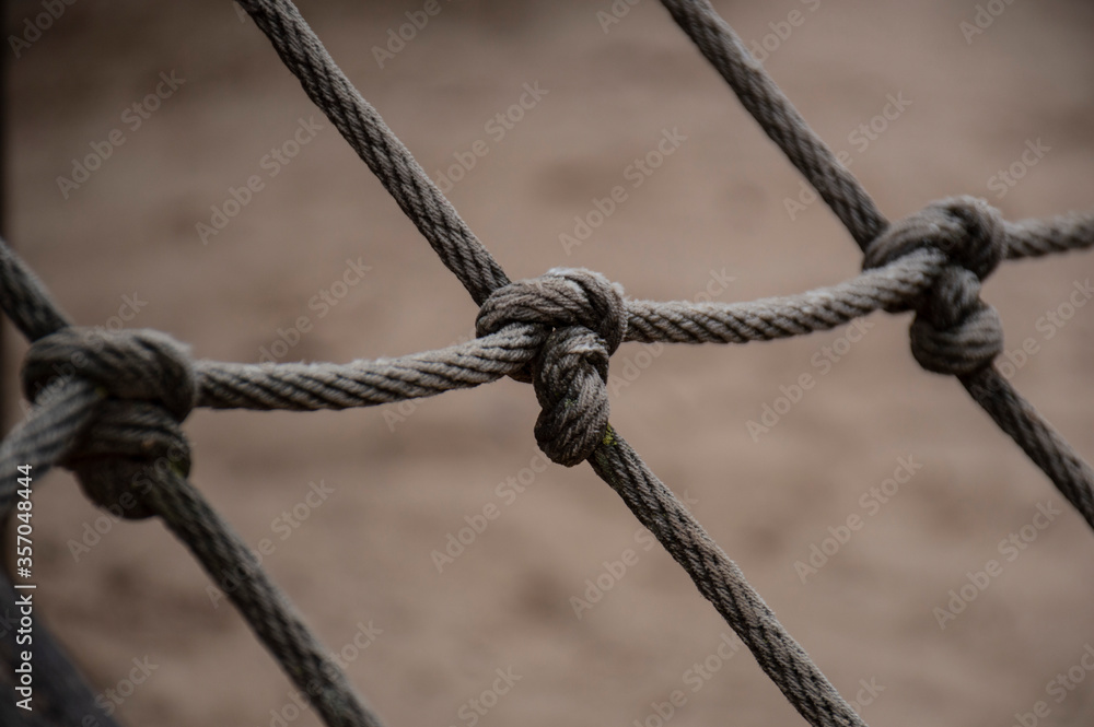 Close-up of knotted ropes with blurry background