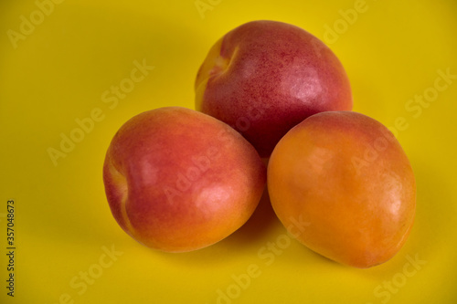 Fresh juicy apricots in a transparent glass plate. Macro.