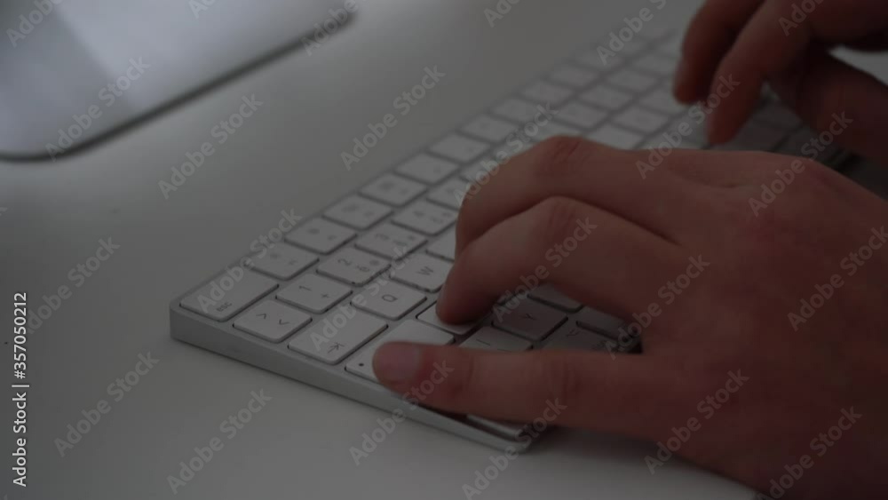 man typing on a computer keyboard man typing on a computer keyboard