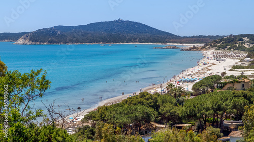 Aerial panoramic view of the beach and sea with azure turquoise crystal clear water, mountains in the background, in Villasimius, Sardinia,Italy. Holidays, the best beaches in Sardinia.