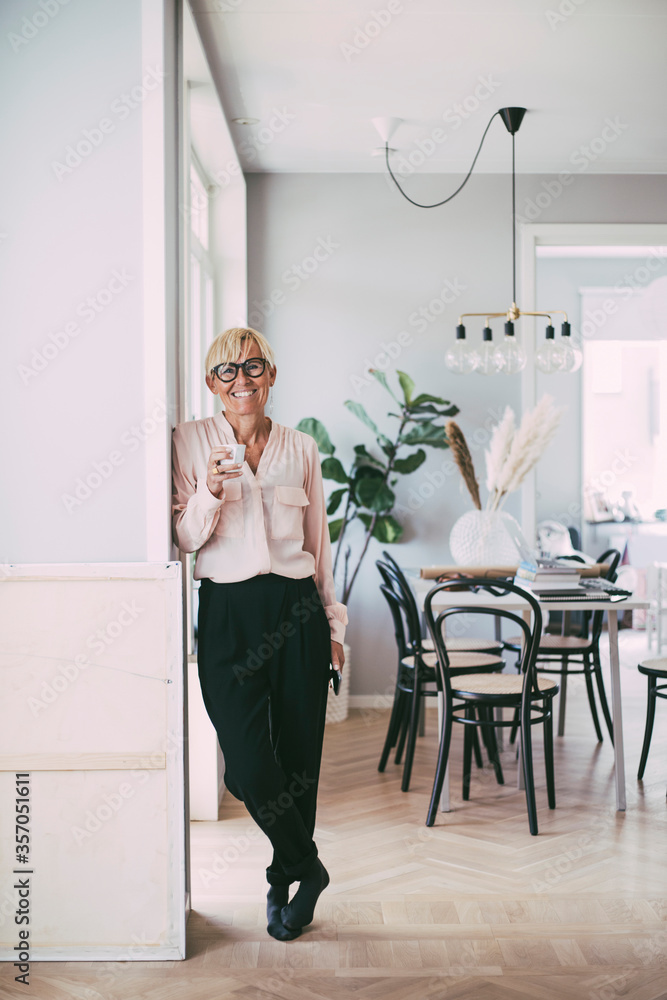 Portrait of woman holding coffee cup at home Portrait of woman holding coffee cup at home
