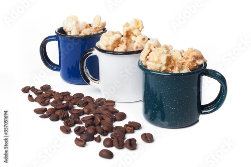 Amazing view of gourmet cinnamon and coffee popcorn with rustic utensils over a white background.