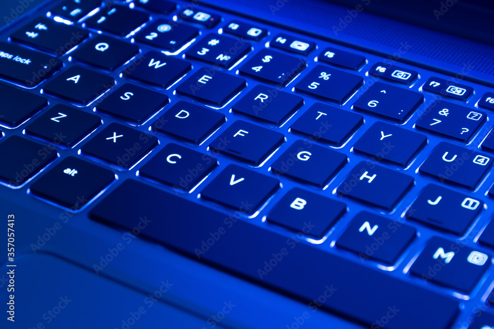 Close Up of laptop keyboard illumination, backlit keyboard